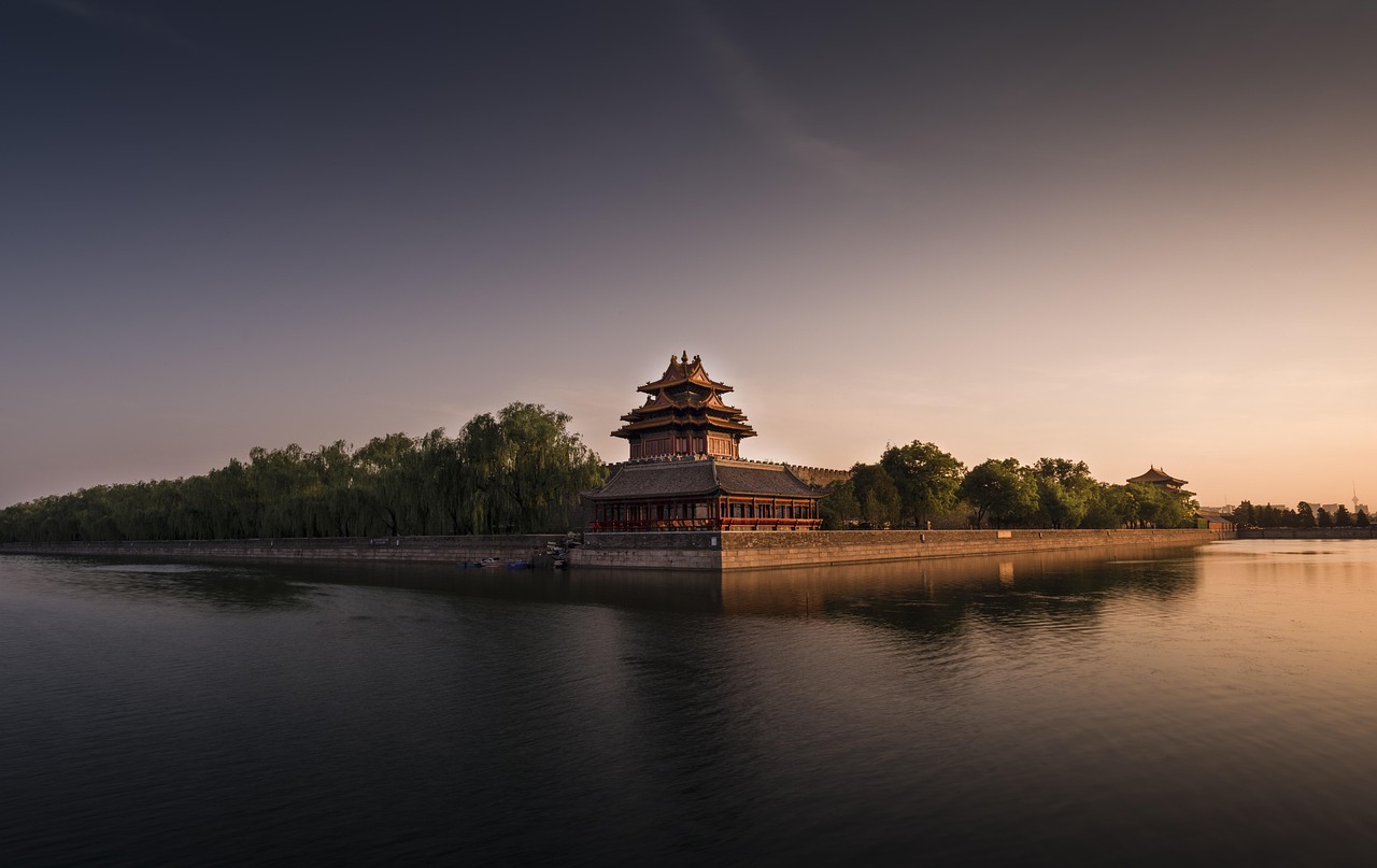 The Great Wall of China winding over green misty mountains at sunrise